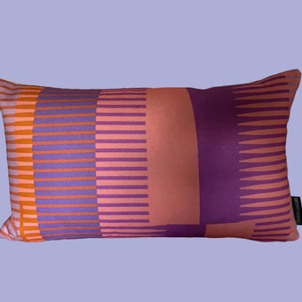 Decorative pillow with purple and orange stripes on a blue background
