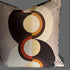 Decorative pillow with circular pattern on a plain background