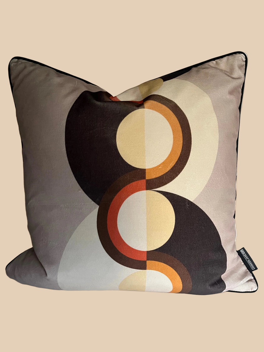 Decorative pillow with circular pattern on a plain background
