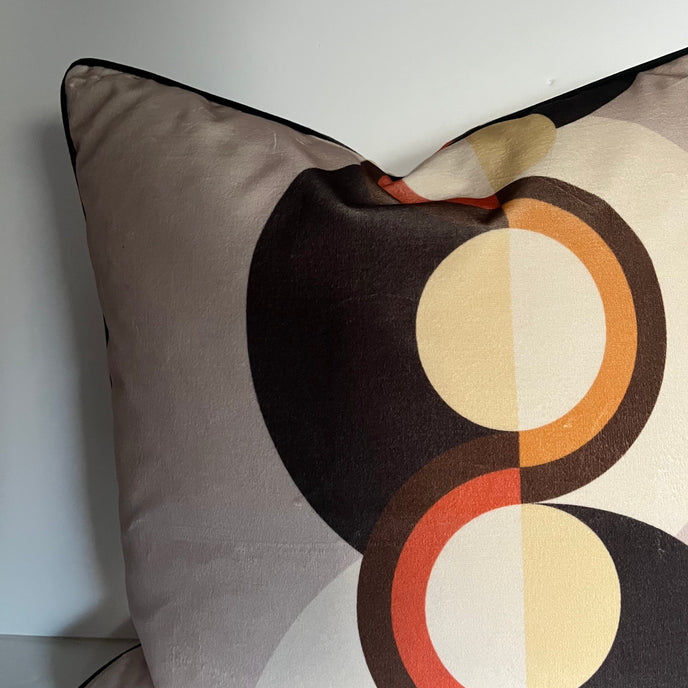 Decorative pillow with circular pattern on a plain background