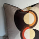 Decorative pillow with circular pattern on a plain background