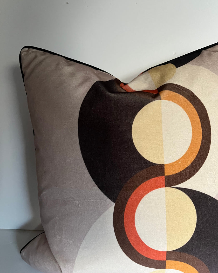 Decorative pillow with circular pattern on a plain background