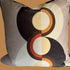 Decorative pillow with circular pattern on a plain background