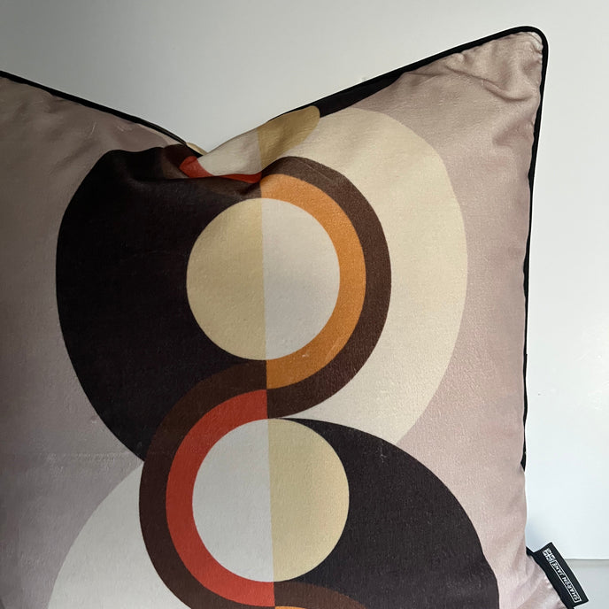 Decorative pillow with circular pattern on a plain background