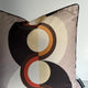 Decorative pillow with circular pattern on a plain background